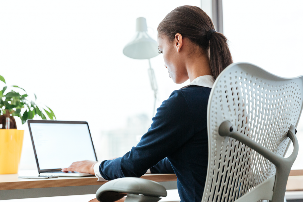 woman on laptop thinking of content for email marketing campaign