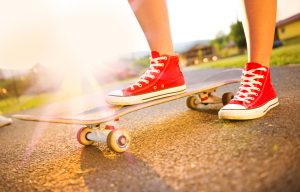 Close up of a young skater girl's feet and skateboard